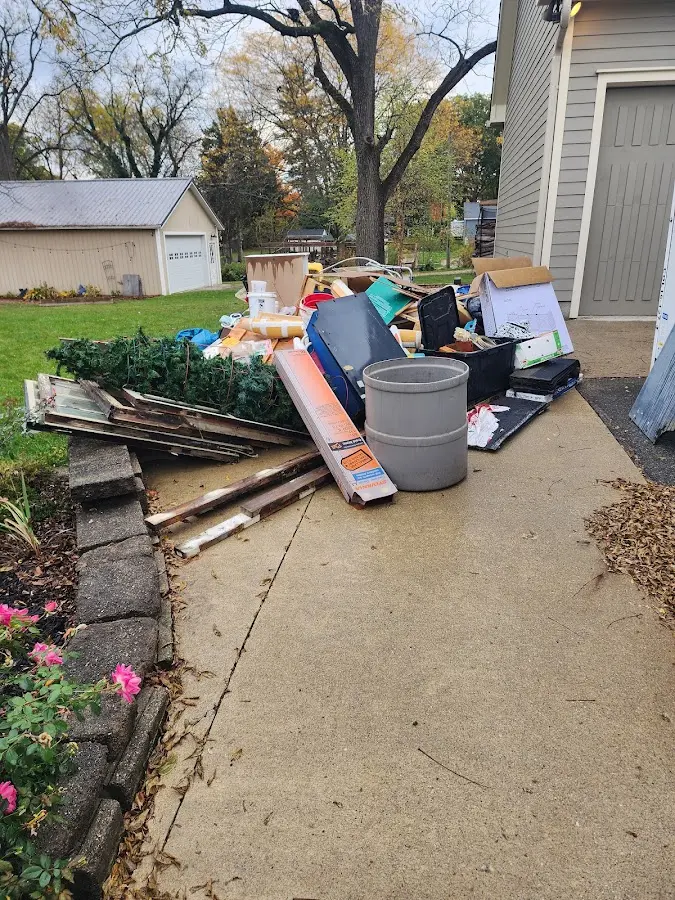 Dumpster being loaded with debris for Estate Cleanout Dumpster Rental in Thruston